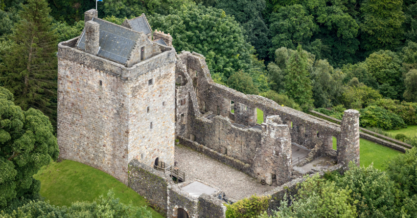 An aerial picture of Castle Campbell surrounded by green trees